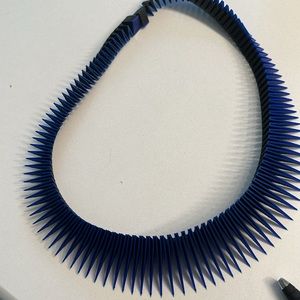 Unique blue and black necklace changes color as it moves.